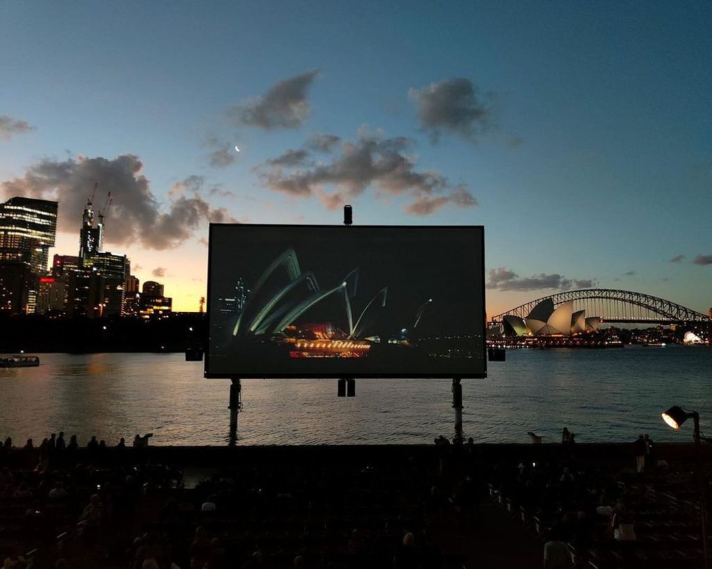 Outdoor cinema screen with sydney harbour bridge in background
